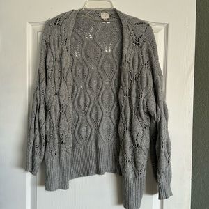 Grey loose knit cardigan with silver balls sewn on throughout.